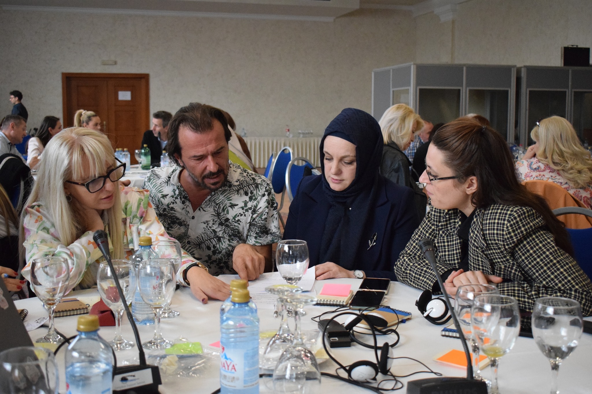 SmartUp facilitators and partners working through a challenge together at a workshop table